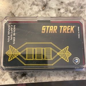 Star Trek movie era captain rank pin. New in box.
